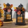 Set Of 2 Battery Operated Lighted Fall Metal Lanterns With Floral Accents And Timer 1 Set Of 2 Battery Operated Lighted Fall Metal Lanterns With Floral Accents And Timer -Decorative Candle Shop set of fall lanterns
